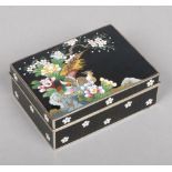 A Japanese cloisonne box with hinged cover. Black ground and decorated with a pair of pheasants