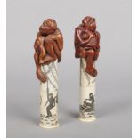 A matching pair of Japanese carved bone scroll holders. Each surmounted with boxwood carved