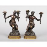 A pair of 19th century French Neo-Baroque figural patinated bronze twin branch candelabra. Formed as