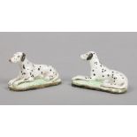 Two small pottery models each modelled as a recumbent dalmatian and raised on an oval plinth, 6.