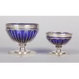 Two old Sheffield plate pedestal bowls with Bristol blue glass liners. Largest 12.75cm.