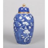 A tall 19th century Chinese blue and white jar and cover. Painted in underglaze blue with the prunus