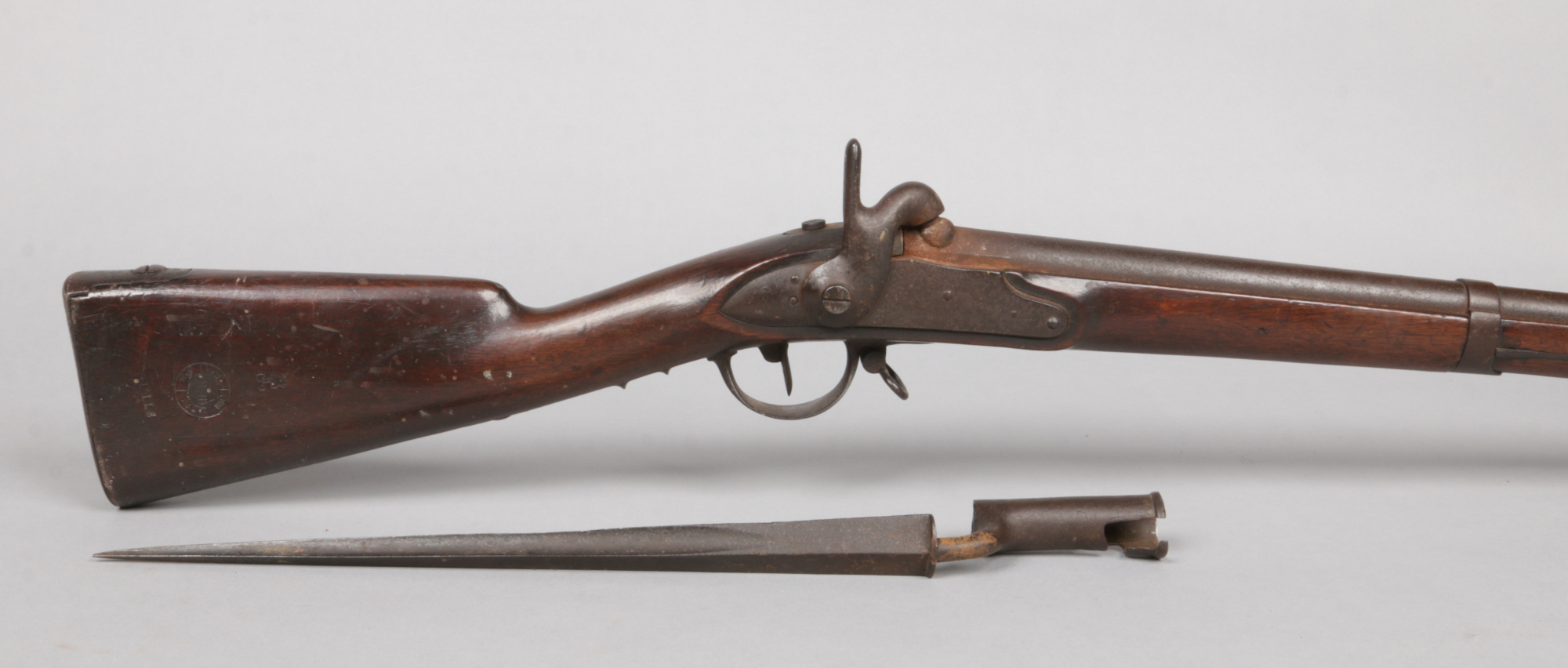 A 19th century French percussion cap musket. With walnut fullstock and socket bayonet. Lock plate