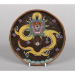 A Chinese copper and cloisonne enamel circular tray. Decorated on a black ground with a yellow