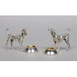 A pair of novelty cast white metal salt sellers. Each formed as a standing hound beside a large bowl