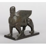 A 19th century French bronze sculpture of a Lamassu. The bearded figure wearing a turban has