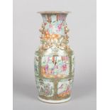 A 19th century Cantonese vase. Moulded with mythical beasts and lizards decorated in gilt, with
