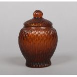 A 19th century Peking glass jar and cover. Amber colour and moulded as a bamboo fence. Seal mark,