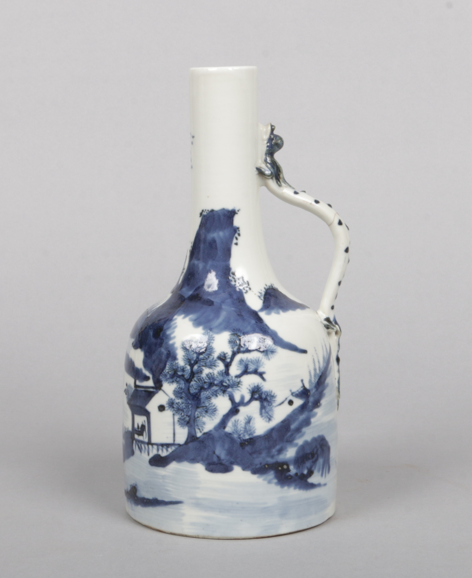 An antique Chinese transitional style blue and white bottle ewer. With scrolling handle having