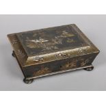 An early Victorian chinoiserie lacquered stationary box of sarcophagus form. With gilt decoration