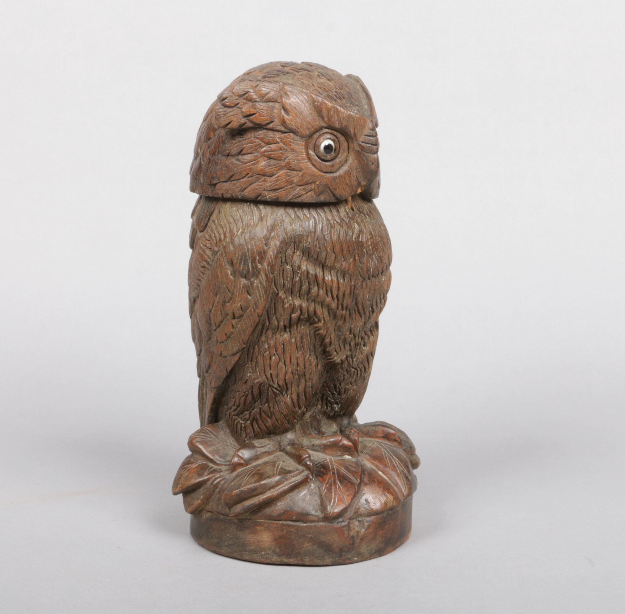 A Black Forest carved walnut tobacco jar and cover modelled in the form of an owl, 28cm.