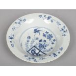 An 18th century English blue and white delft soup plate, probably Vauxhall. Painted with flowers and