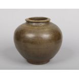 A Chinese Yuan dynasty earthenware jar decorated in tea dust glaze, 21.5cm.