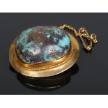 A yellow metal mounted turquoise pebble brooch, 3cm.