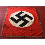 A World War II German Third Reich linen banner. Red ground, with swastika motif an having silver