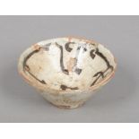 An early Persian small terracotta bowl. White glazed and with Nishapur Kufic script, 11.5cm