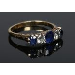 An 18 carat gold sapphire and diamond five stone ring, size Q.
