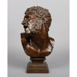 A 19th century patinated bronze bust of oversize proportions. Modelled in the Greek style of a man
