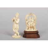 Two 19th century Indian ivory carvings. One formed as a figure playing a flute, the other a pair