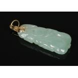 A Chinese carved pale celadon jade pendant with 14 carat gold mount, 36mm.