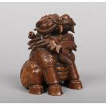 A 19th century Chinese bamboo carving of a seated kylin, 14.5cm.