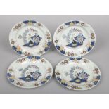 A set of four 18th century Lambeth polychrome delft plates. Painted with leaves and flowers in blue,