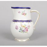 A Chelsea Derby cider jug with rib moulded neck. Painted with flowers in the manner of Edward