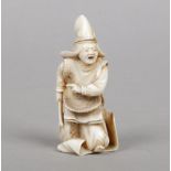 A small Japanese Meiji period carved ivory okimono. Formed as a Samurai warrior. Signed to the