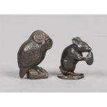 Two miniature cast metal models of animals. One formed as an owl and the other a mouse eating a