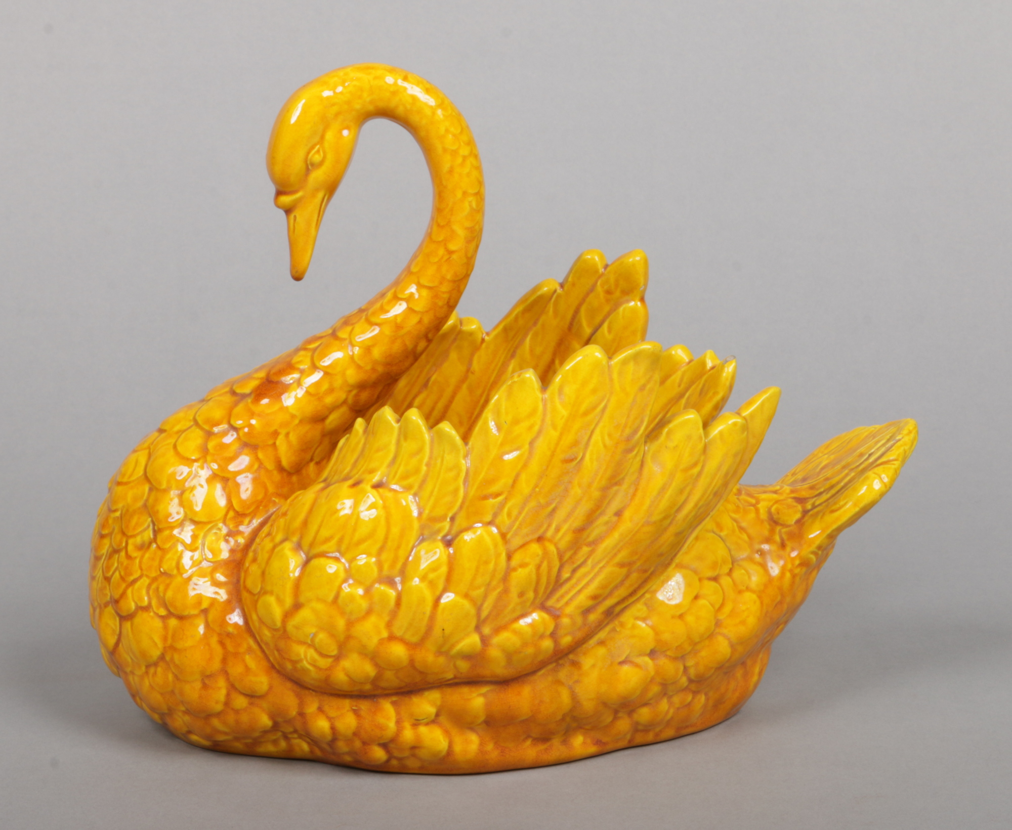 A Burmantofts Faience planter. Modelled in the form of a swan and glazed in yellow. Impressed