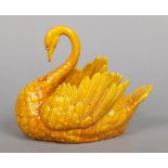 A Burmantofts Faience planter. Modelled in the form of a swan and glazed in yellow. Impressed