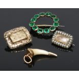 Two Georgian mourning pins, a gold mounted tooth pendant and a green paste circlet brooch.