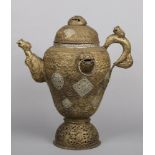 A large Indian brass ewer with hinged cover. With pierced and repousse decoration and ornamented