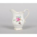 A Chelsea Derby helmet shaped cream jug. Painted with flowers in the manner of Edward Withers