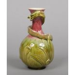 A Burmantofts Faience vase of baluster shape and glazed in green and red. Moulded with a serpent