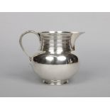 A large Victorian silver ale jug by Goldsmith's & Silversmith's Company. With ribbed neck and reeded