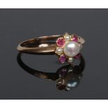 An early 20th century ruby spinel and pearl ring of cruciform setting, size P.