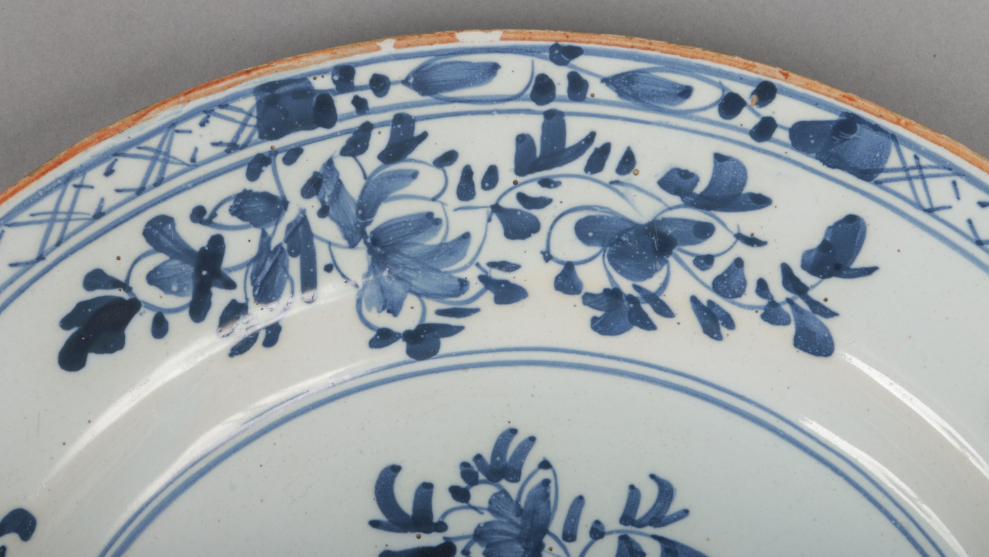 An 18th century English delft blue and white plate, probably Liverpool. Painted with a floral - Image 3 of 4