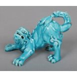 A Burmantofts style turquoise glazed model of a lion dog, 8cm high. Provenance; The F. C. Upton