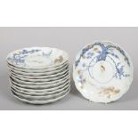 A set of 12 Japanese scalloped dishes. Painted in underglaze blue and gilt with pine trees and