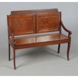 A mahogany hall bench. With blind fret carved cresting rail, pair of quarter veneered back panels