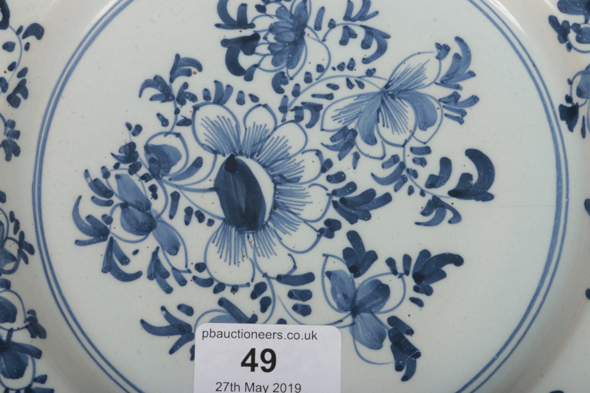 An 18th century English delft blue and white plate, probably Liverpool. Painted with a floral - Image 4 of 4