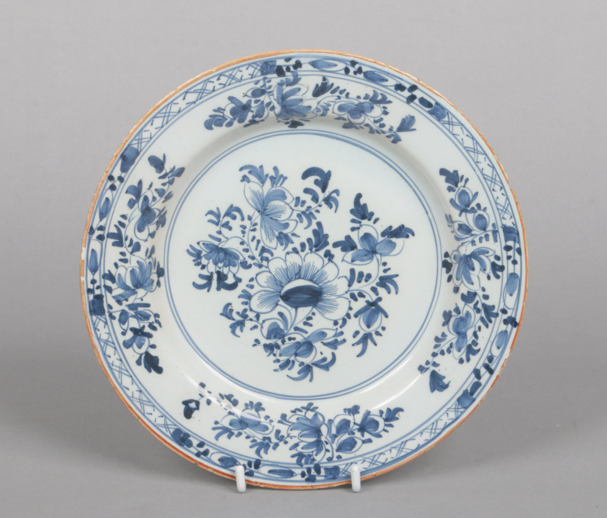 An 18th century English delft blue and white plate, probably Liverpool. Painted with a floral