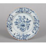 An 18th century English delft blue and white plate, probably Liverpool. Painted with a floral