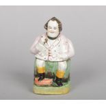 A 19th century Staffordshire figural tobacco jar and cover. Coloured in enamels and formed as a