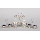 A French silver and glass three piece table cruet. Comprising an oil and vinegar bottle set on stand