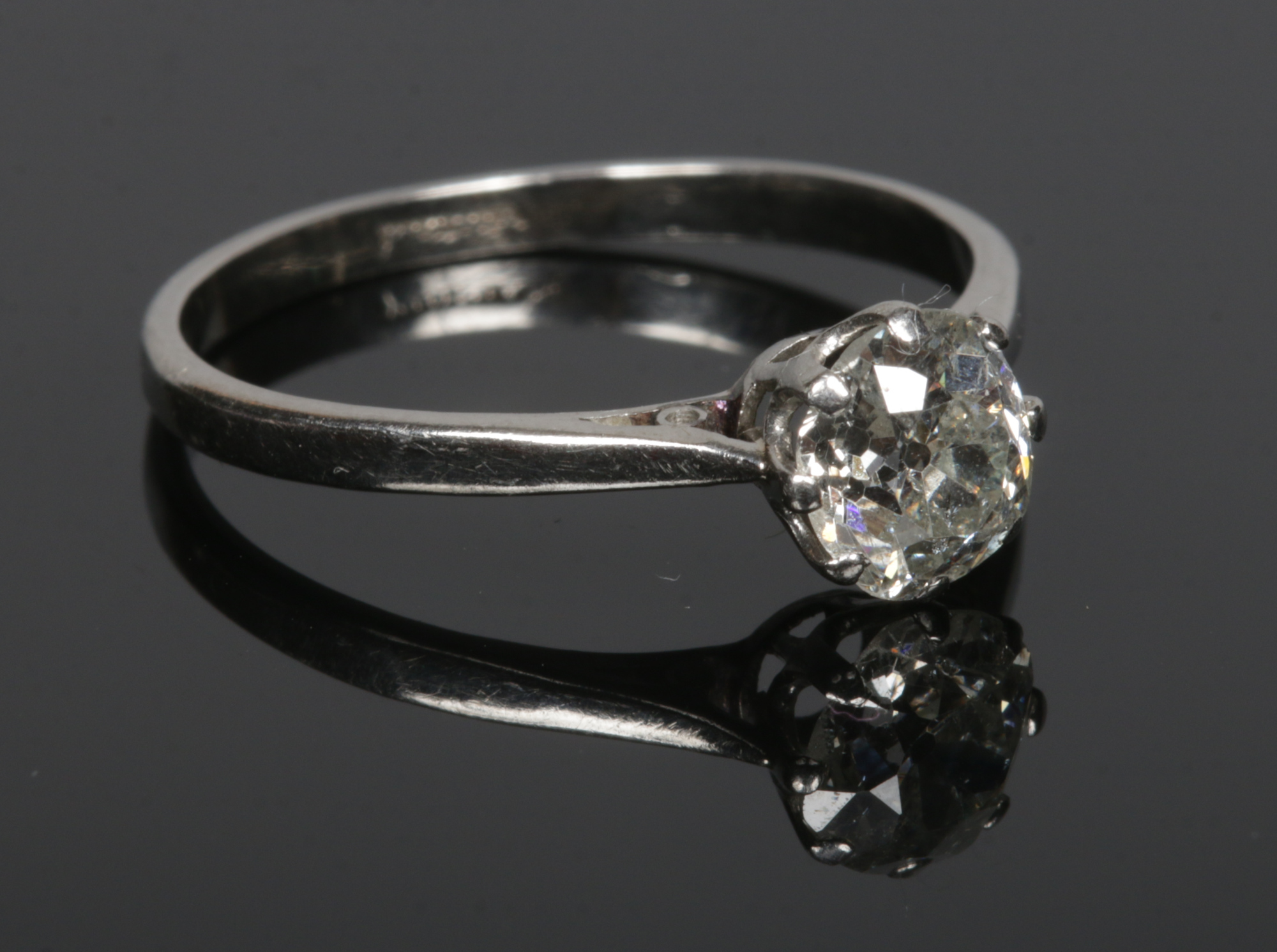 A platinum and old mine cut solitaire diamond ring. Diamond approximately 1.13ct, size R.Condition