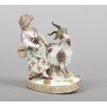 A 19th century Meissen figure of a girl herding a goat. Decorated in coloured enamels and raised