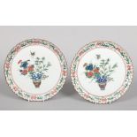 A pair of 19th century Japanese plates with scallop moulded rims. Painted in coloured enamels with