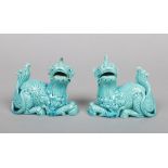 A pair of Burmantofts Faience models of Kirin in resting pose and decorated in turquoise glaze.